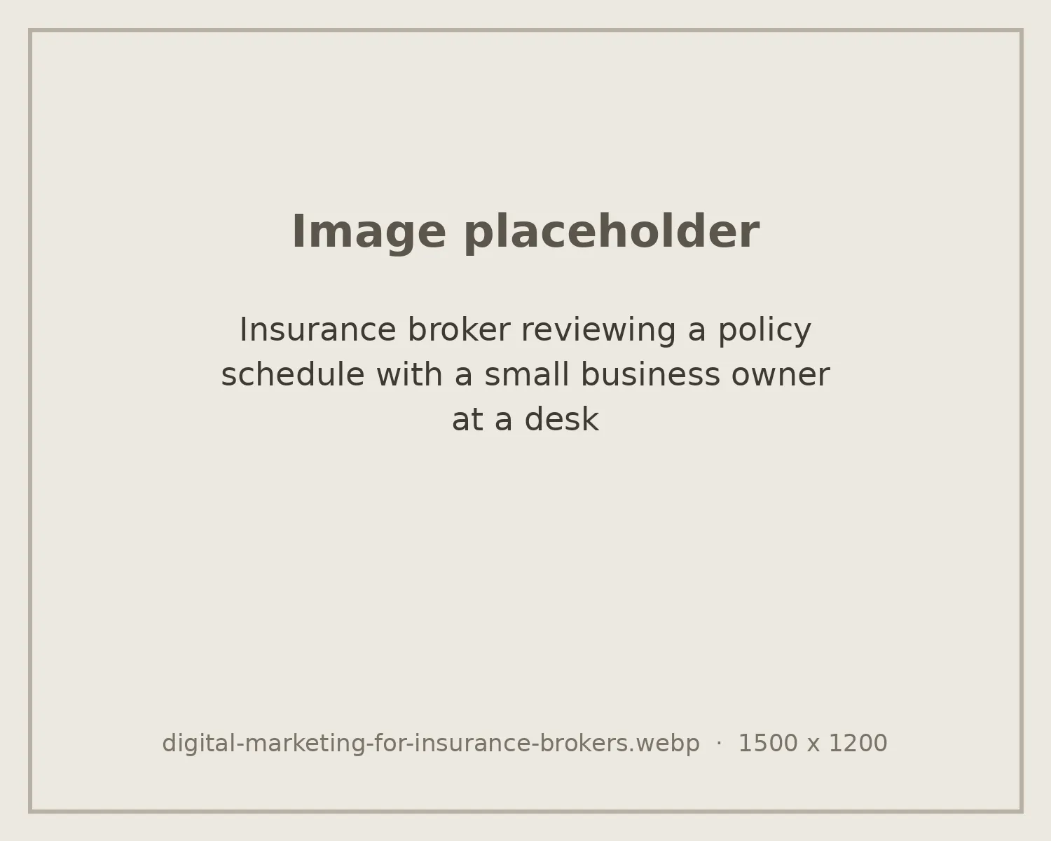 Insurance broker reviewing a policy schedule with a small business owner at a desk